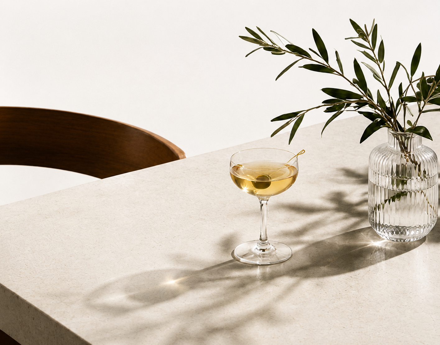 Cocktail and olive branch on a restaurant table